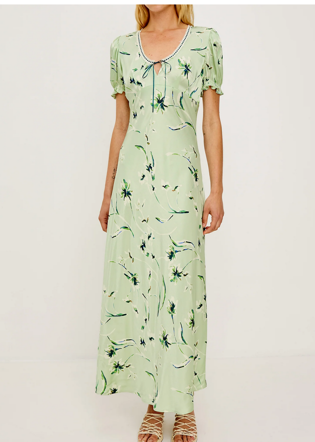 Person wearing the Rails Allison Dress in Mint, featuring a light green floral satin crepe fabric with puff sleeves, a scoop neckline, and small front keyhole detail, standing against a plain background.