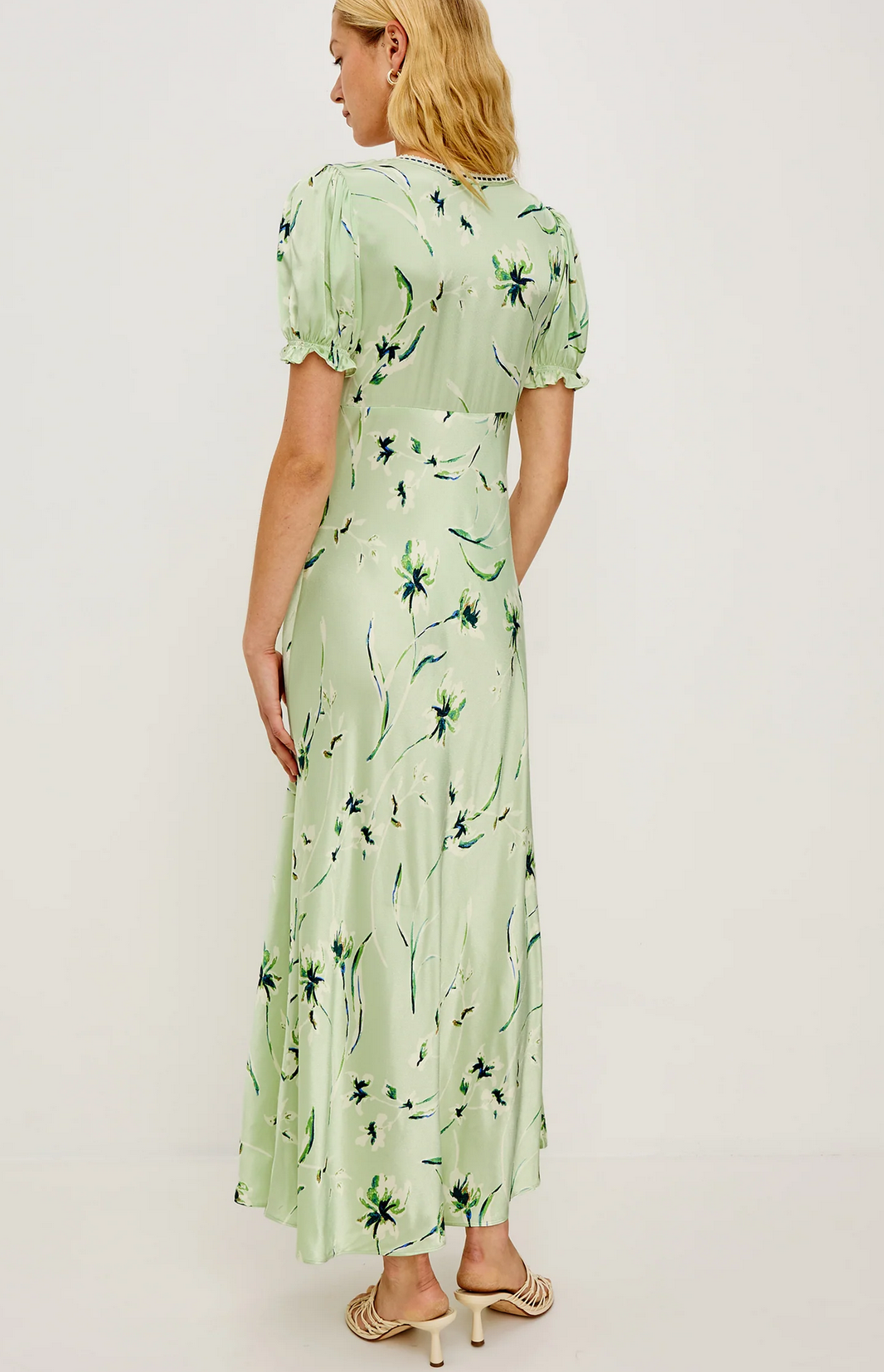 A woman stands with her back to the camera, wearing the Rails Allison Dress in mint with short puff sleeves and beige heeled sandals, set against a plain background.