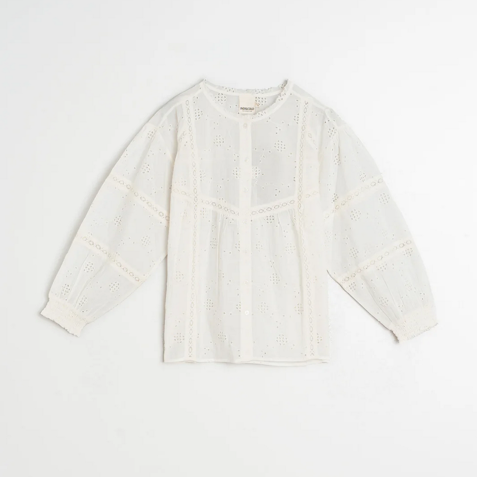 White blouse by indi and cold on a light beige background