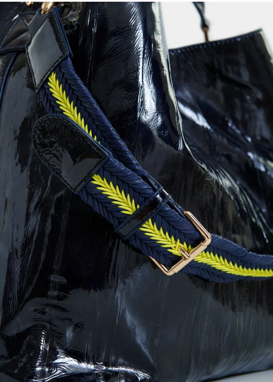 Essentiel Antwerp navy patent faux-leather JISTALO shopper handbag with a yellow strap on a white background