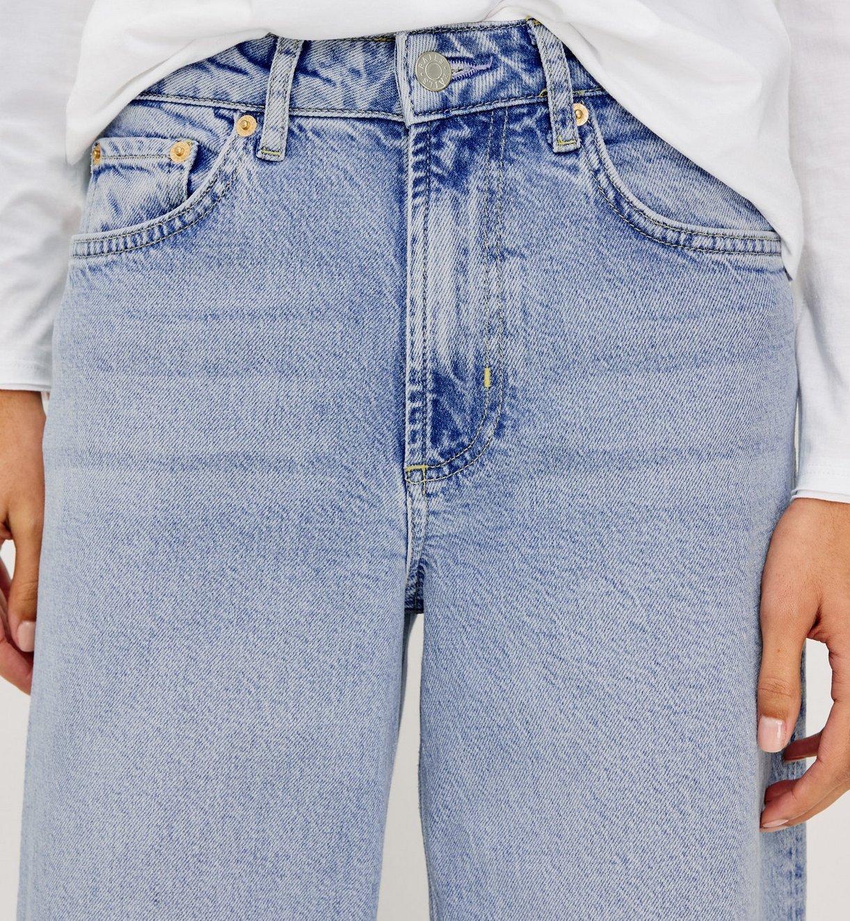 Model wears the Rails Getty Wide Leg - Light Blue jeans with a white long-sleeve shirt, standing hands at sides.