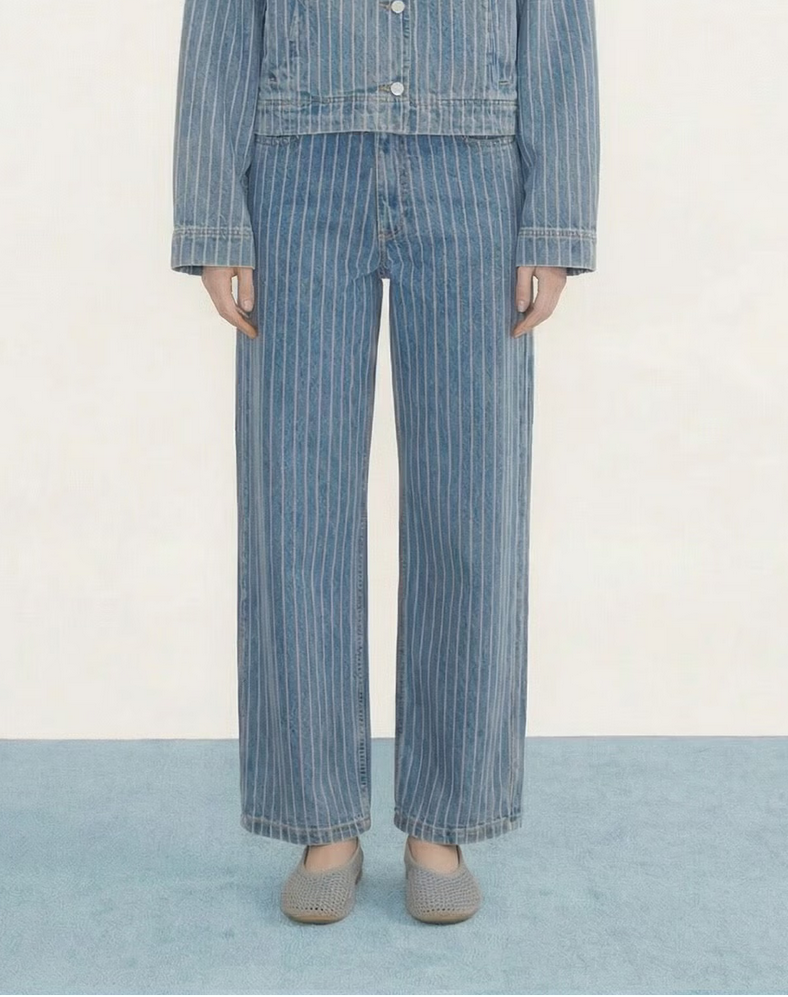 Woman wearing a blue denim outfit on a white background