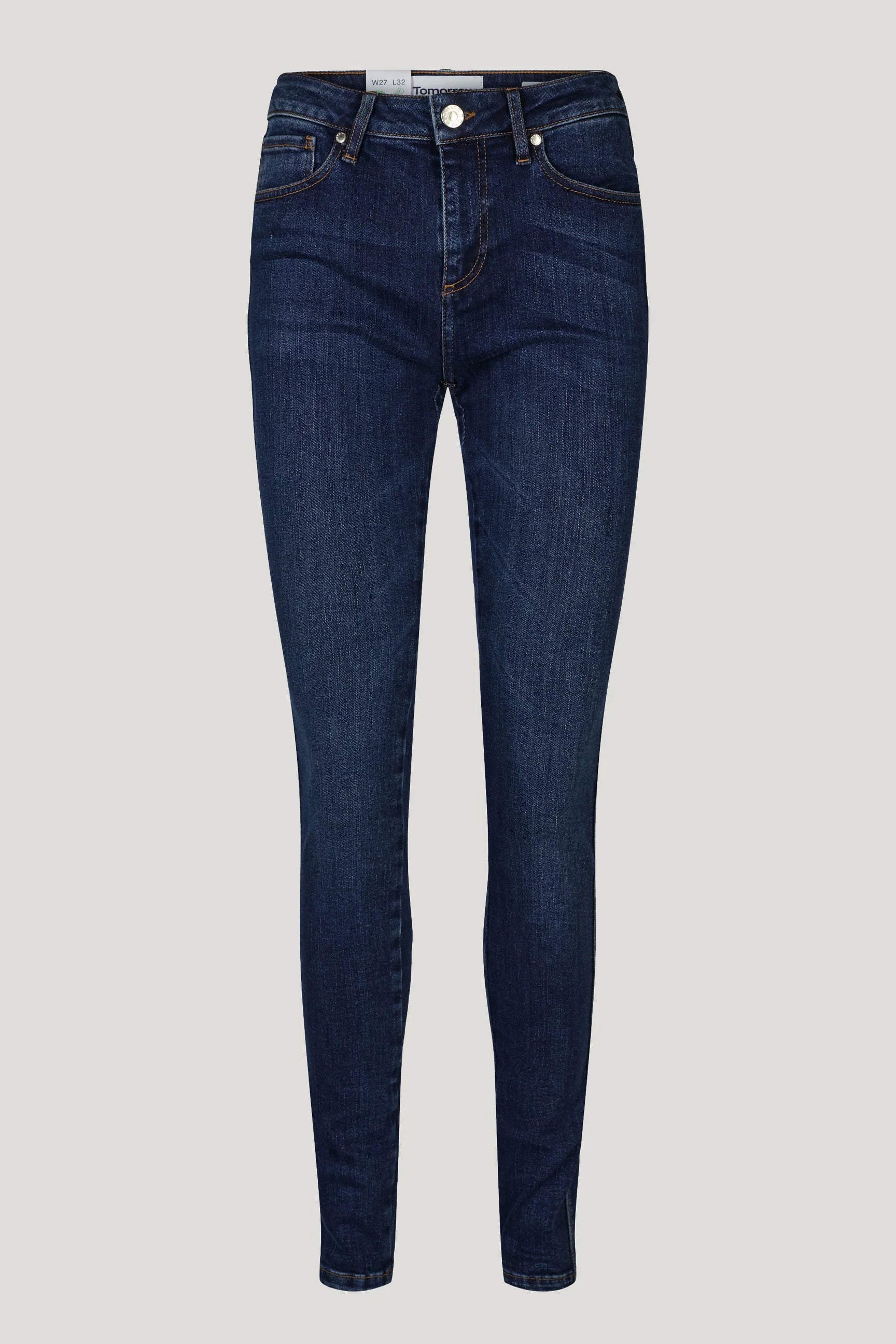A woman's Dylan Mid Waist Jeans - Prato in dark blue denim made from organic cotton by Tomorrow Denim.