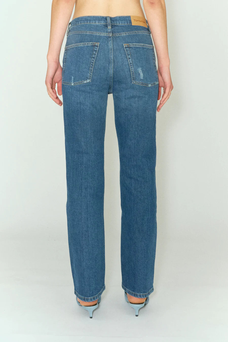 The back view of a woman wearing a pair of Marston Jeans - Key West made from organic cotton by Tomorrow Denim.