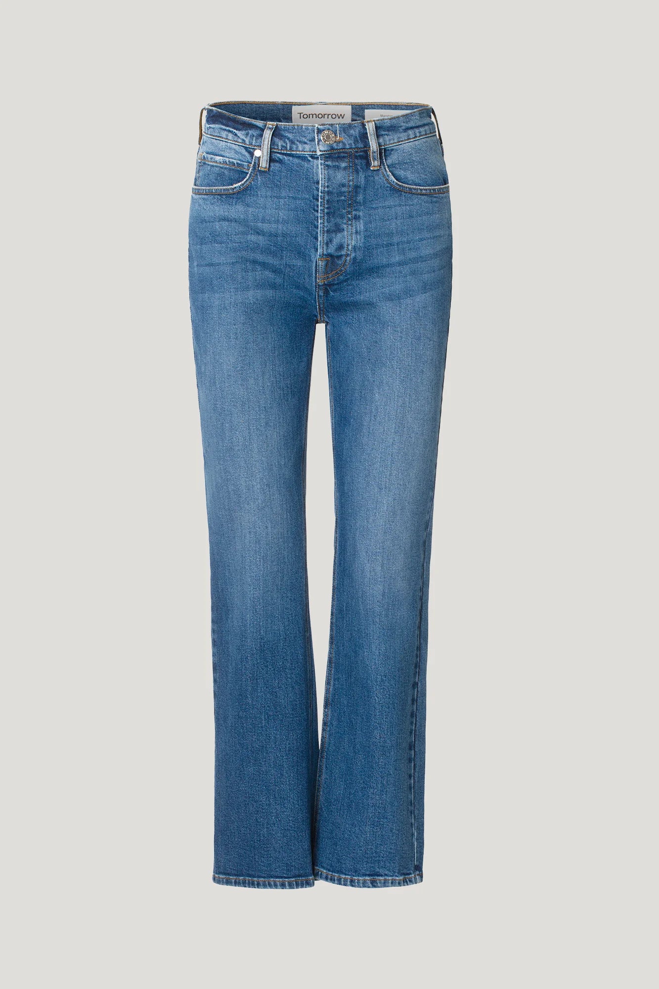 A woman's Marston Jeans - Key West, straight leg jeans in blue denim made from organic cotton by Tomorrow Denim.