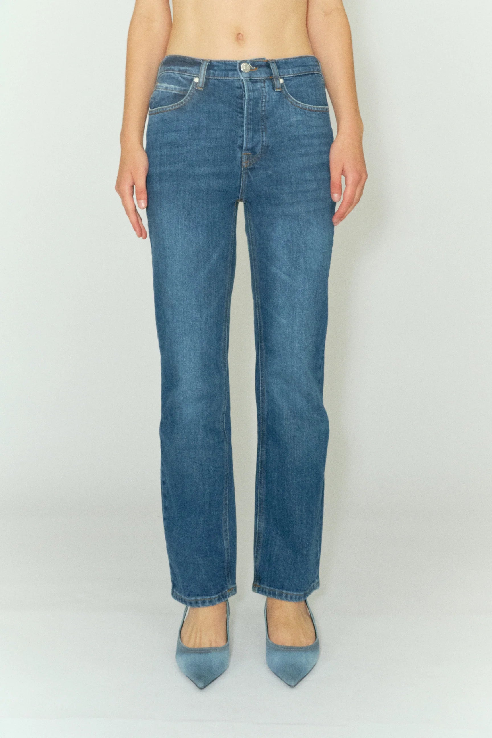 A woman is standing in a pair of Tomorrow Denim's Marston Jeans - Key West.