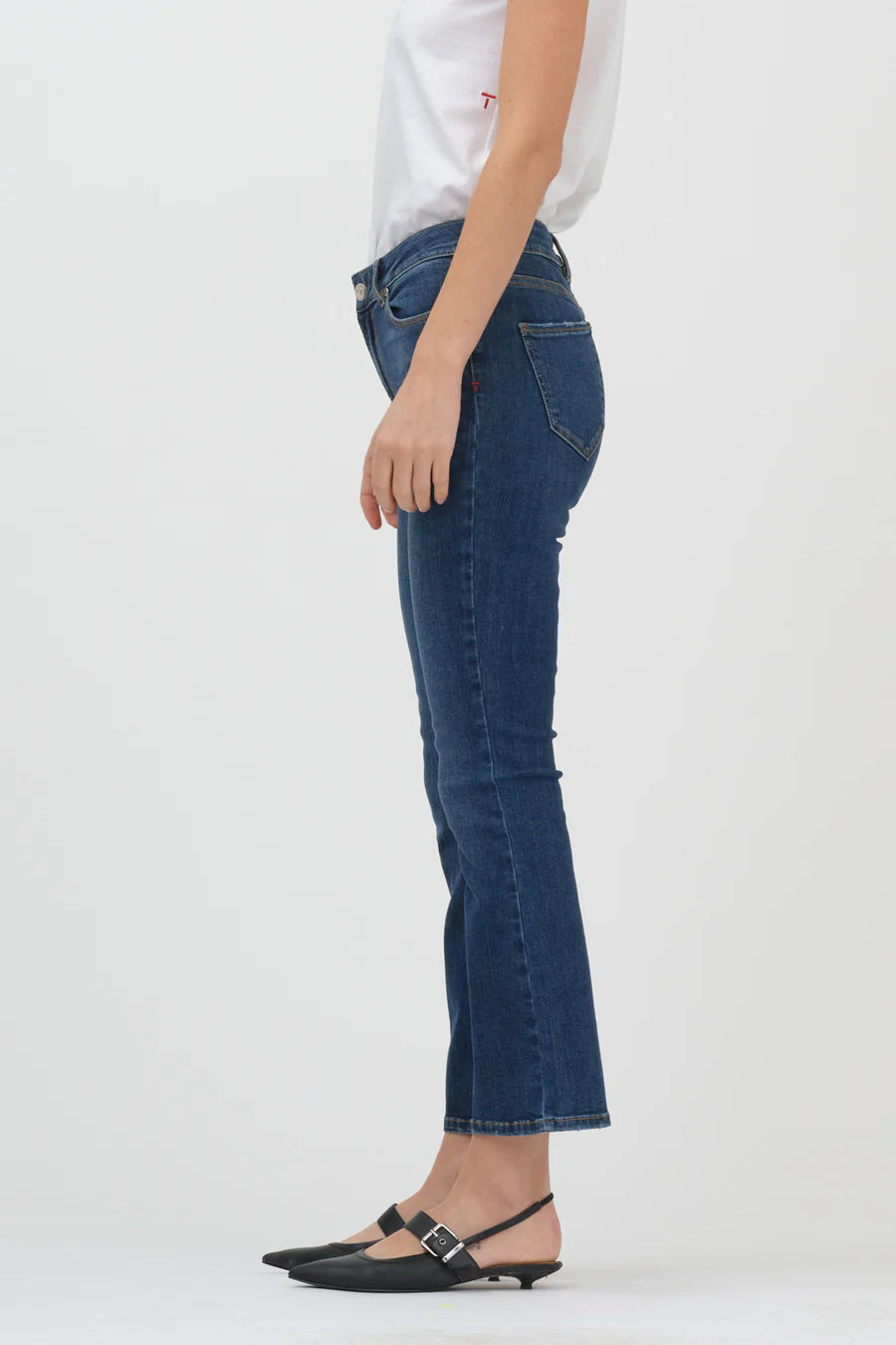 The back view of a woman wearing a pair of Tomorrow Denim's Malcolm Jeans - Denver, high waist, kick flare leg jeans.