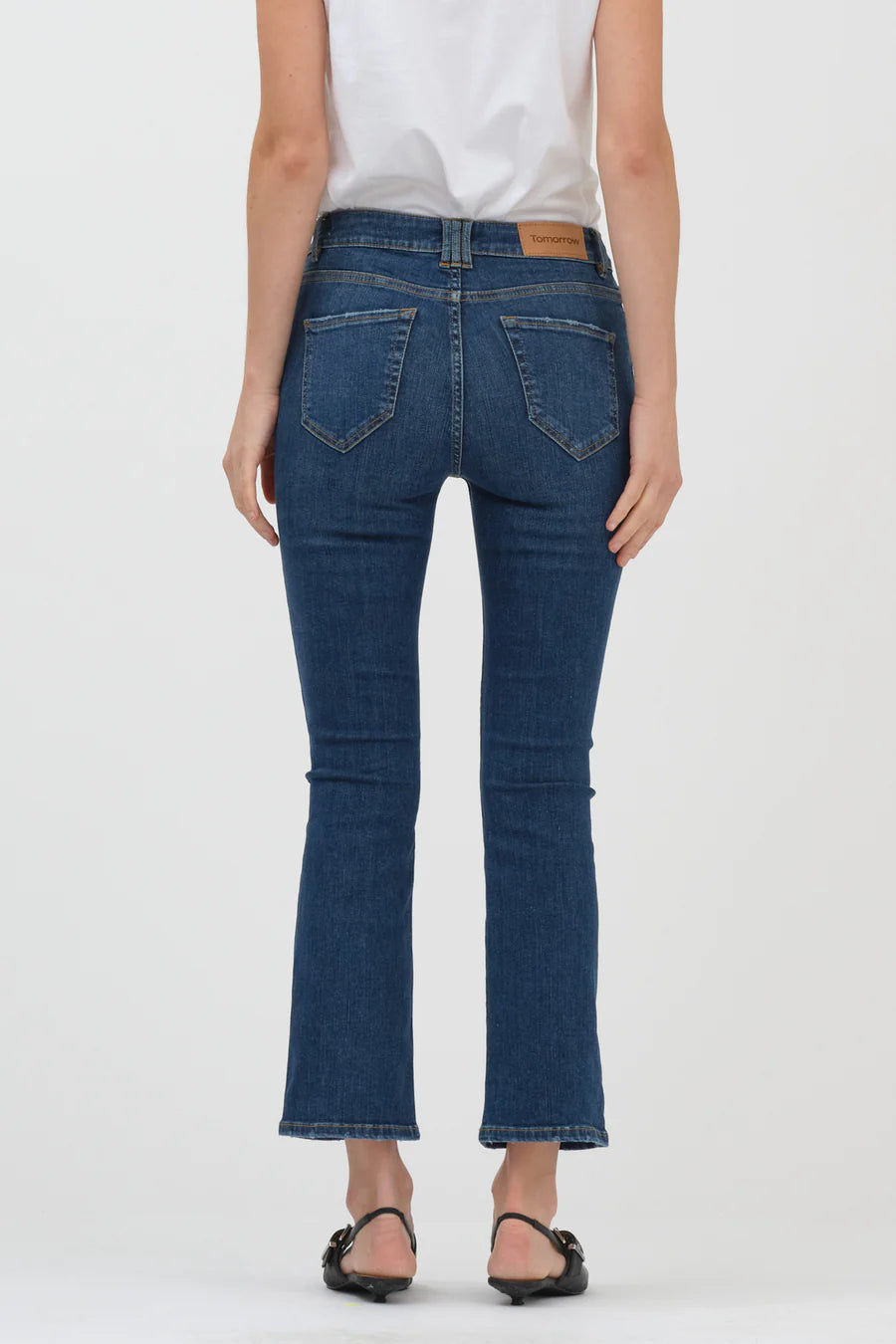The back view of a woman wearing a pair of Tomorrow Denim - Malcolm Jeans - Denver.
