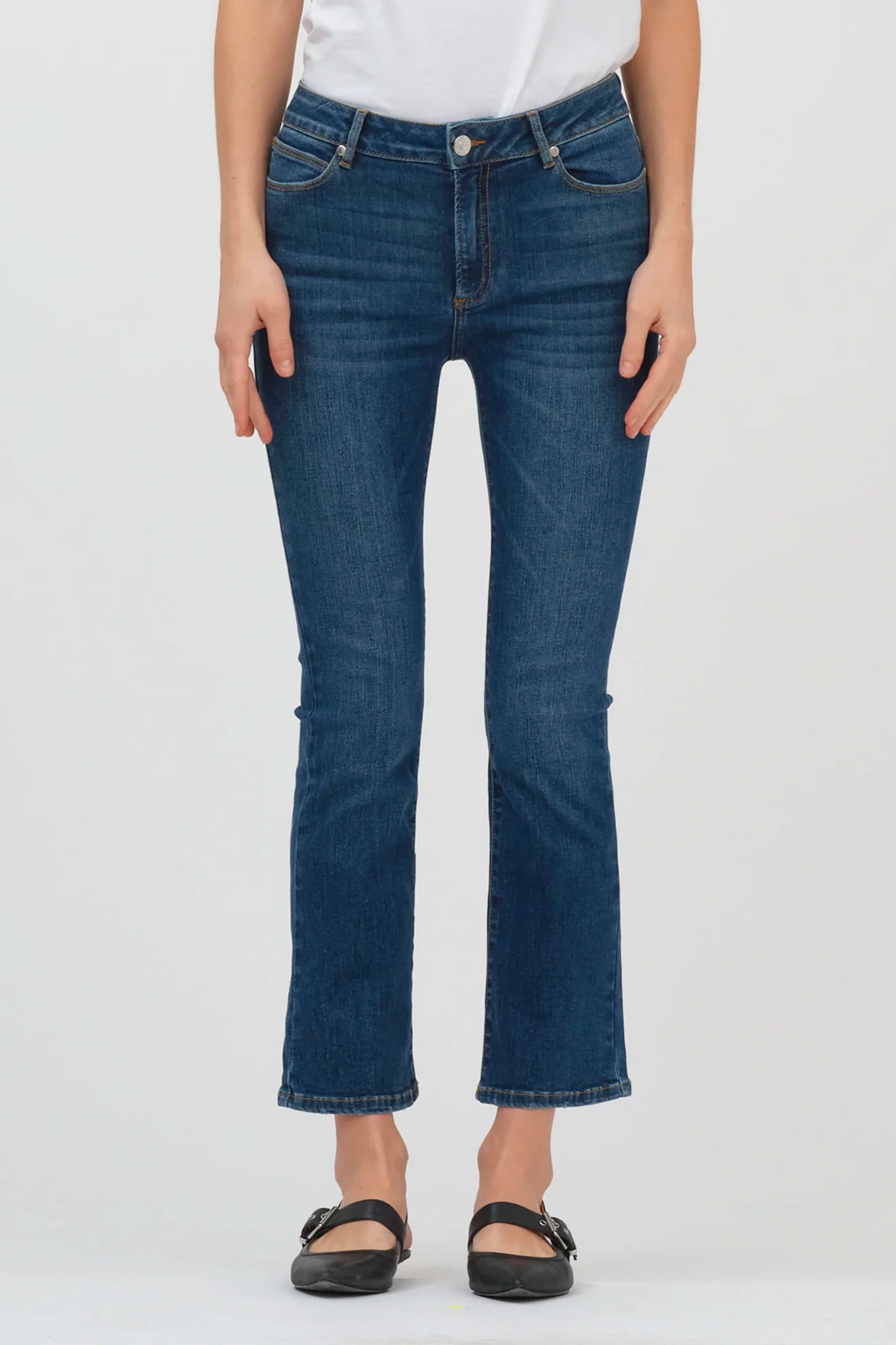 A woman wearing a pair of Malcolm Jeans - Denver kick flare leg jeans made from stretchy fabric by Tomorrow Denim.