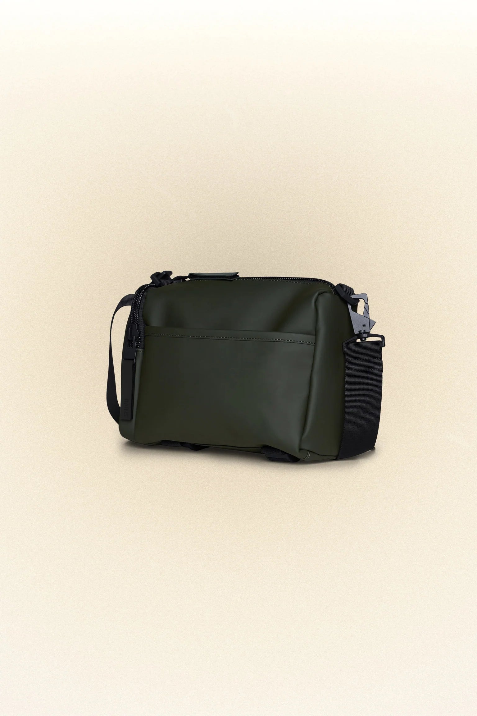 The Rains Texel crossbody bag, a small black bag with a handle, perfect for carrying daily essentials.