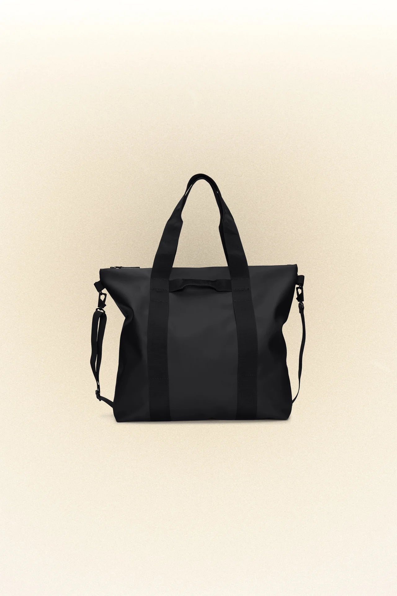A Rains black waterproof tote bag on a white background.