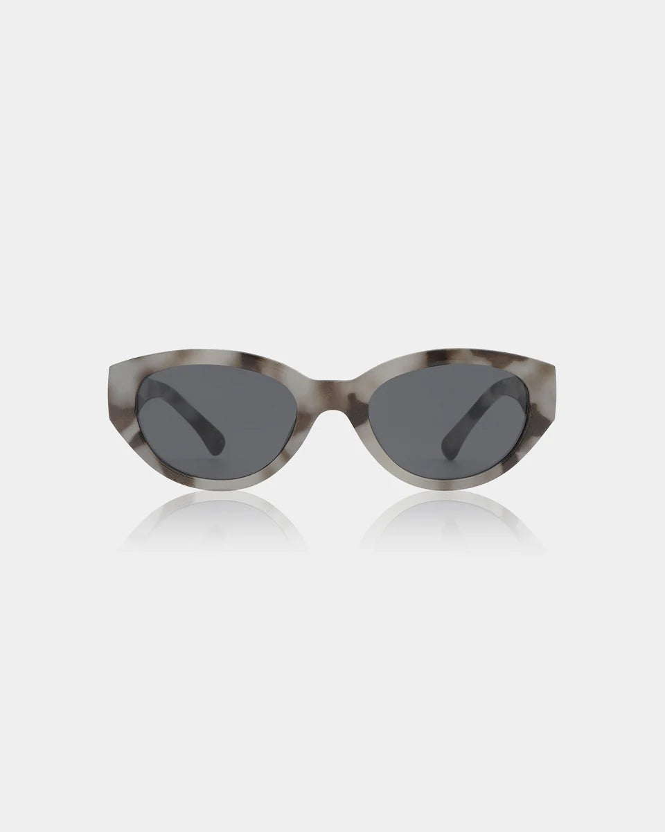 Winnie Sunglasses - Cookie Dough by A. Kjærbede are gray cat-eye frames with dark lenses, crafted from recycled materials and inspired by Scandinavian style, displayed on a plain white background.