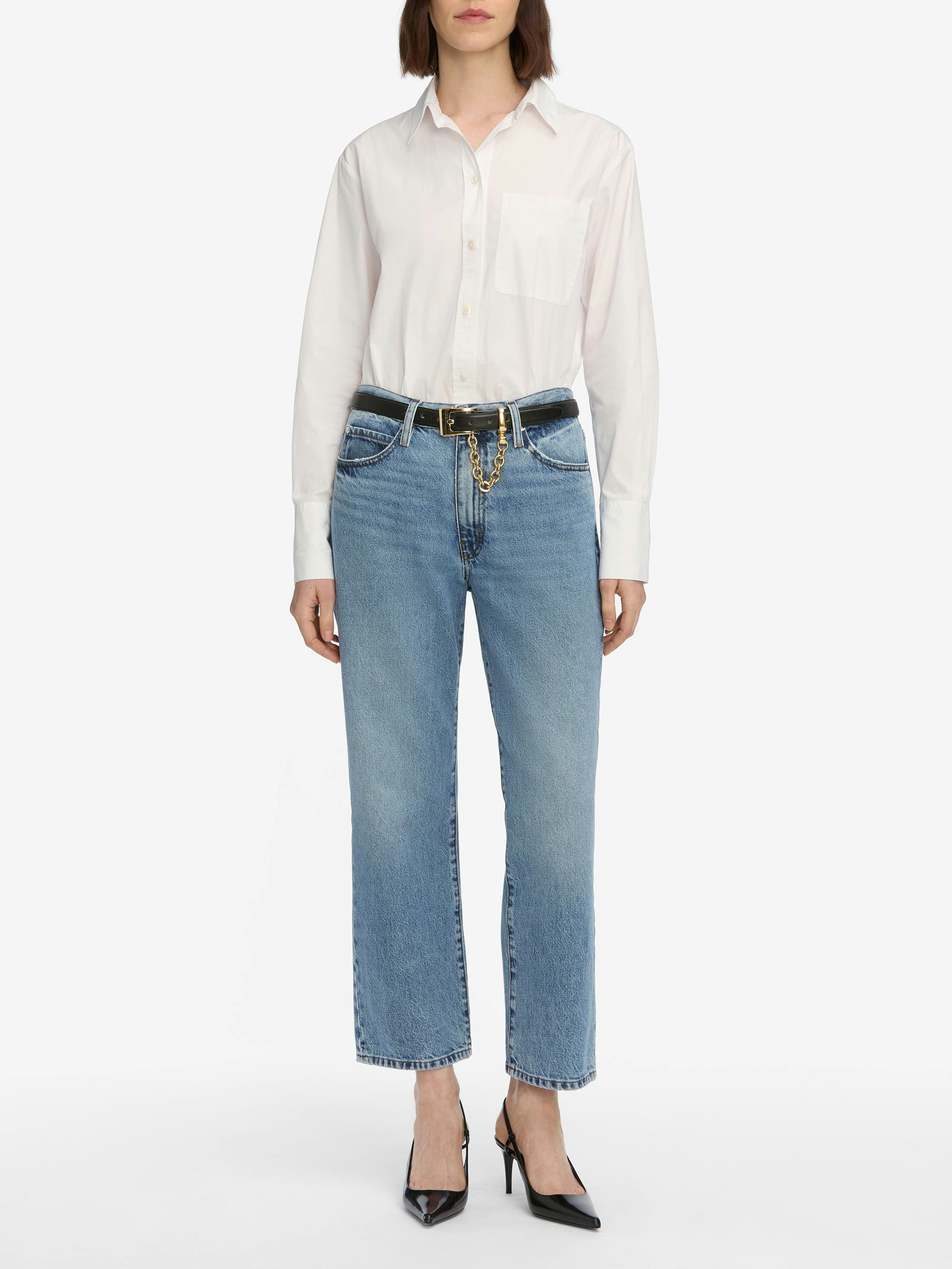 Person wearing a white shirt and blue jeans on a white background