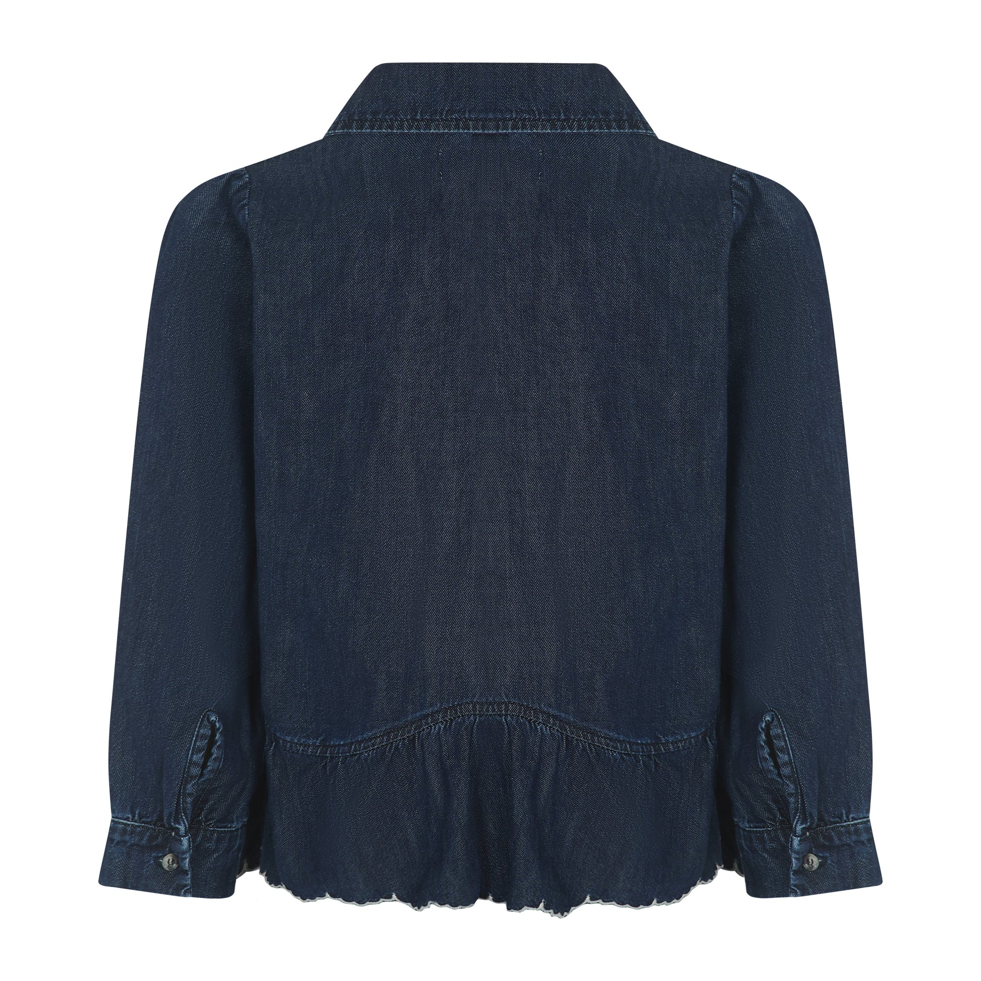 The Tate Blouse - Americana by Seventy & Mochi is shown from the back in dark blue denim, featuring long sleeves with buttoned cuffs, a collar, and a gently gathered, slightly ruffled hem.