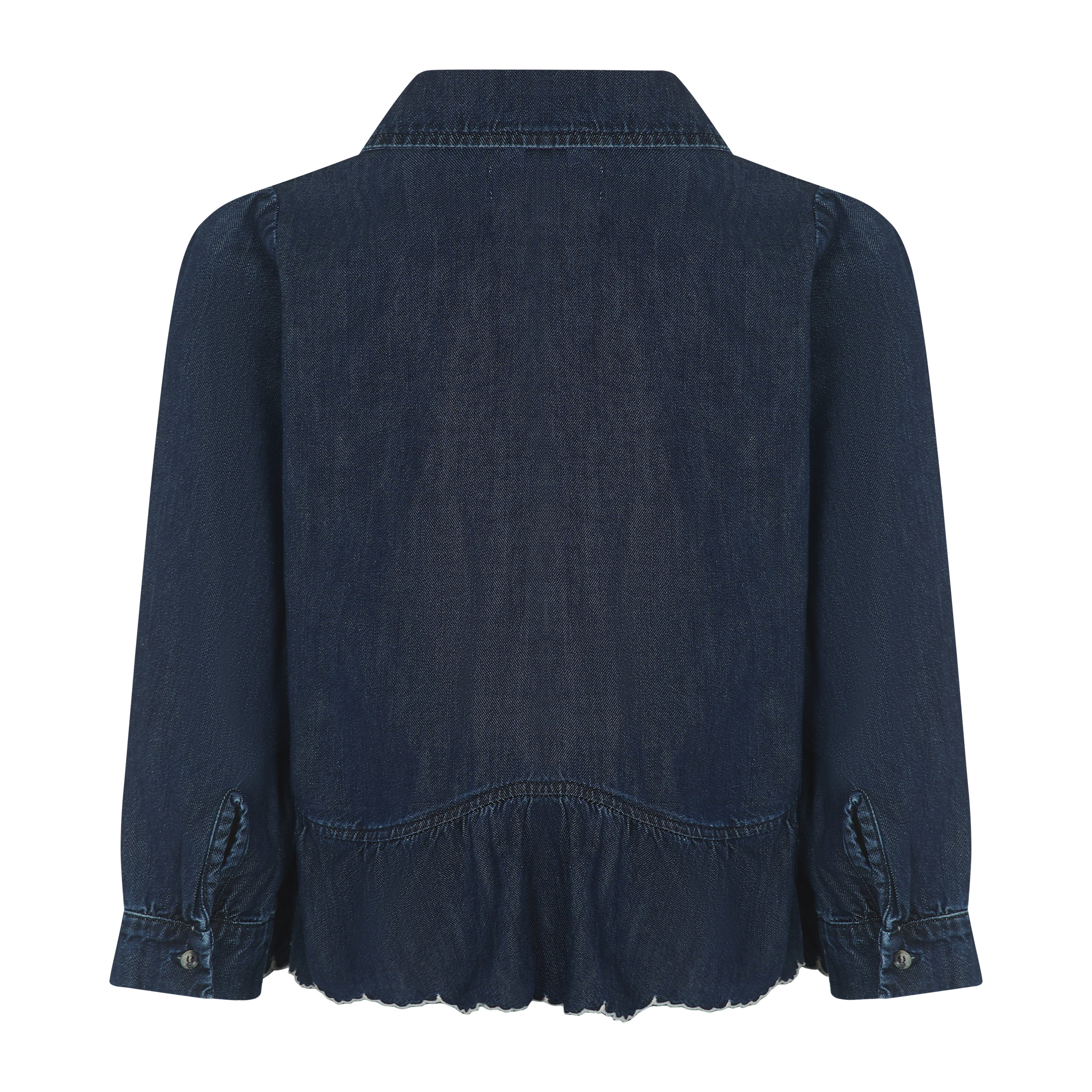 The Tate Blouse - Americana by Seventy & Mochi is shown from the back in dark blue denim, featuring long sleeves with buttoned cuffs, a collar, and a gently gathered, slightly ruffled hem.