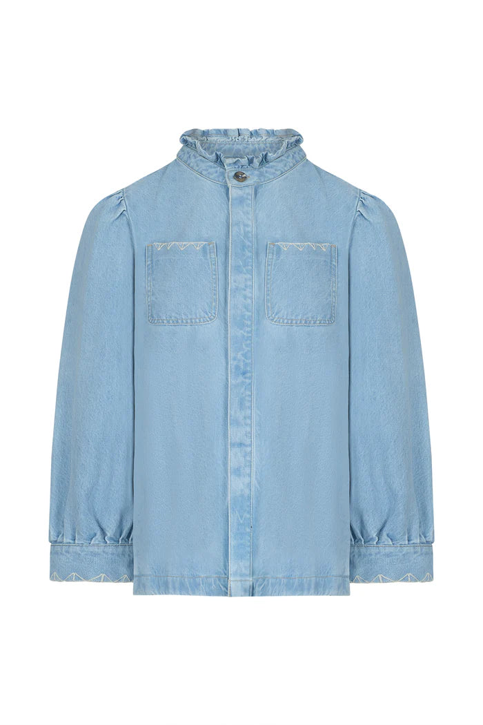 The Dana Denim Jacket - Sunbleached by Seventy & Mochi features long puffed sleeves, two chest pockets, a ruffled collar, geometric embroidery accents, and front button closure in light-wash denim.
