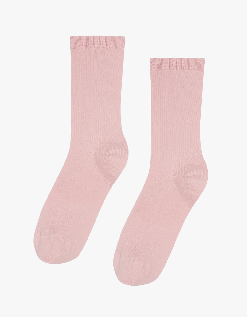 A pair of Colorful Standard Classic Organic Socks in pink, seamless and breathable, on a white background.