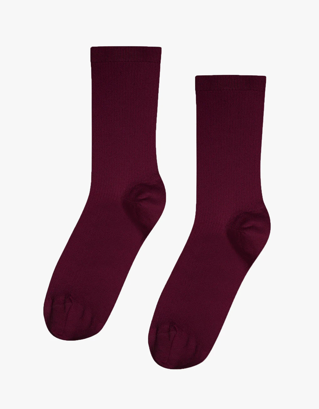 A pair of Colorful Standard Classic Organic Socks, maroon in color, seamless and breathable, made from organic cotton on a white background.