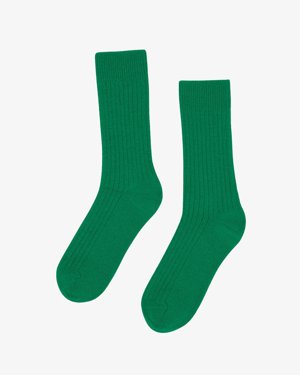 A pair of green Colorful Standard Merino Wool Blend Socks is displayed on a white background.