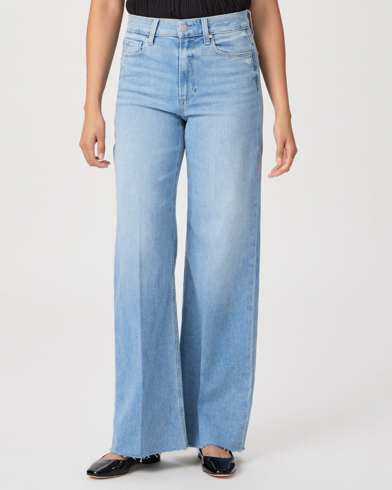 Woman wearing blue high-waisted, Paige Anessa Wide Leg 31"- Helena denim jeans and black shoes.