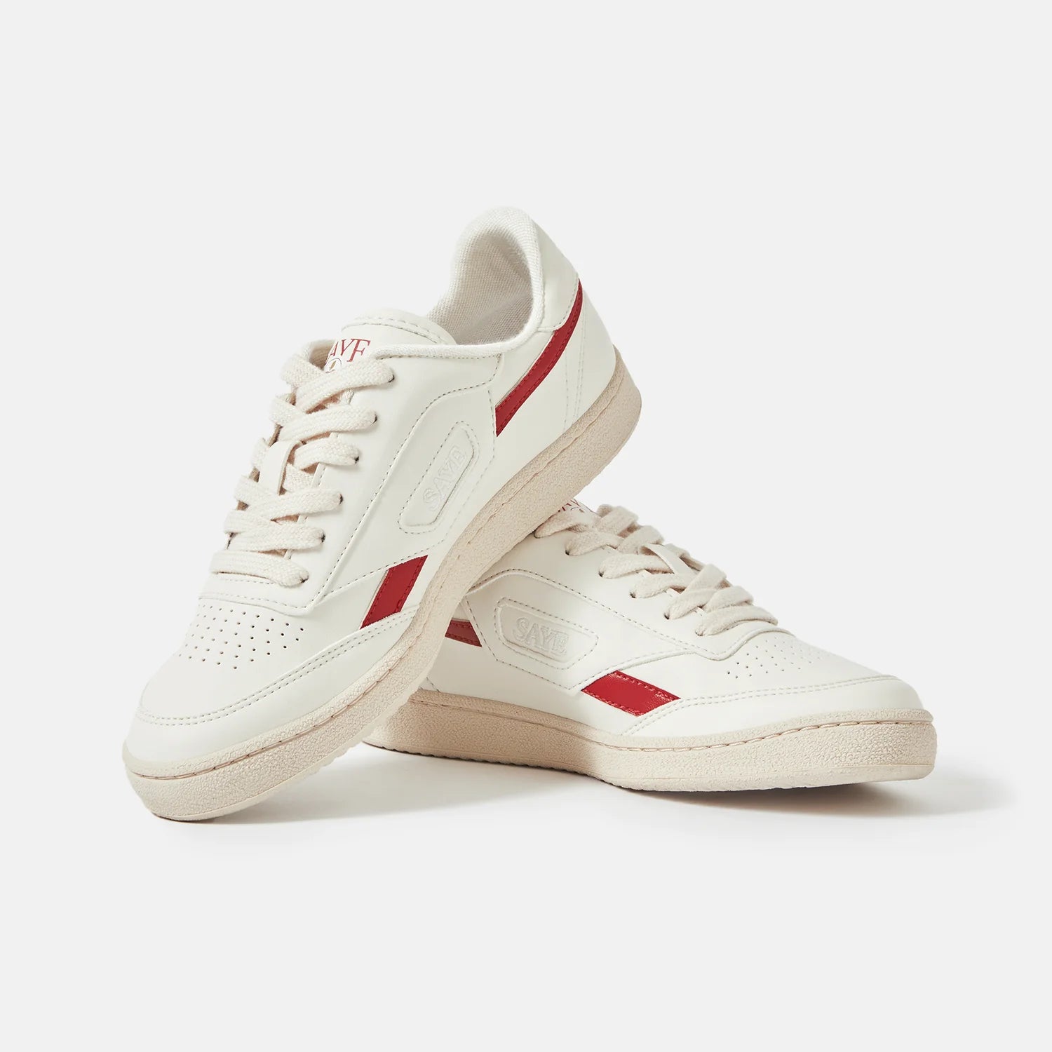 A pair of Modelo '89 sneakers in vegan Napa material, Apple red edition by SAYE, on a white surface.