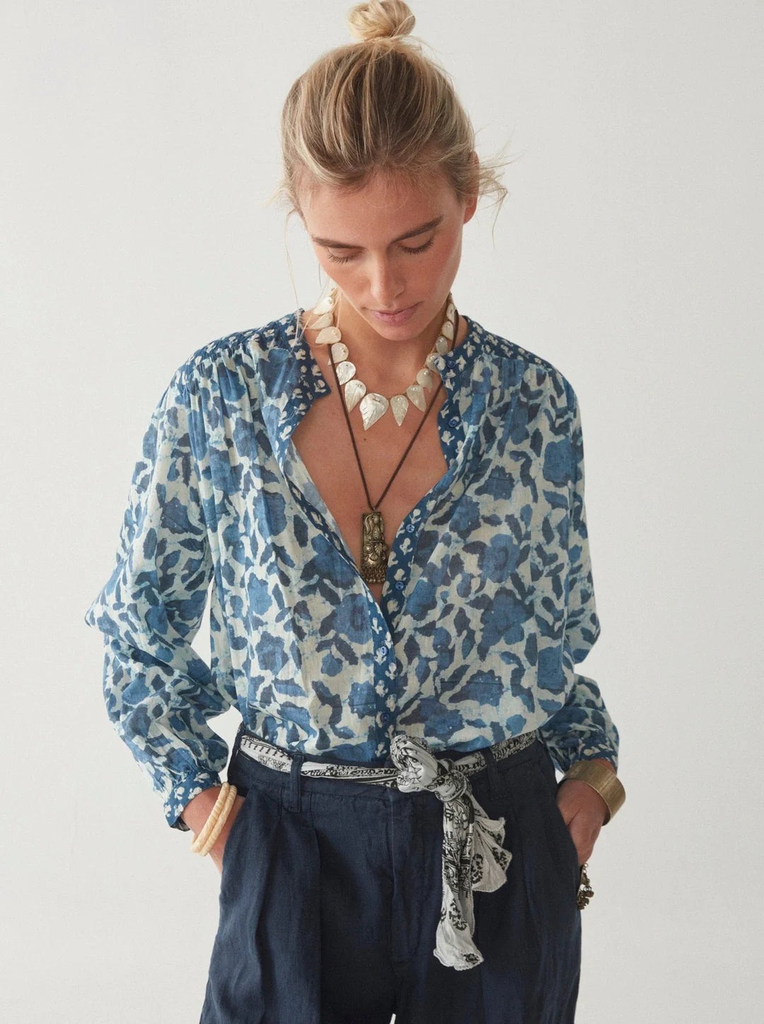 Model wears boho blouse with blue floral print 