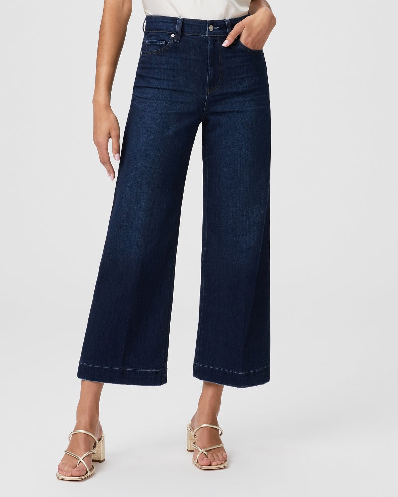 A woman is wearing a pair of Paige Anessa Wide Leg - The Disco ultra high-waisted cropped jeans.