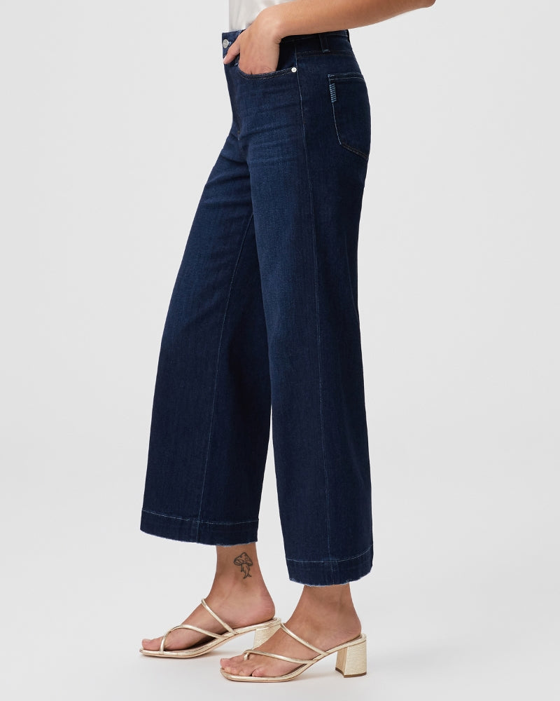 A woman rocking a pair of ultra high-waisted jeans with a wide leg silhouette, made from Paige's Anessa Wide Leg - The Disco denim.