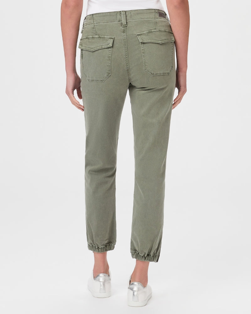 The back view of a woman wearing Paige Mayslie Jogger - Vintage Ivy Green cargo pants, showcasing the utility trend.