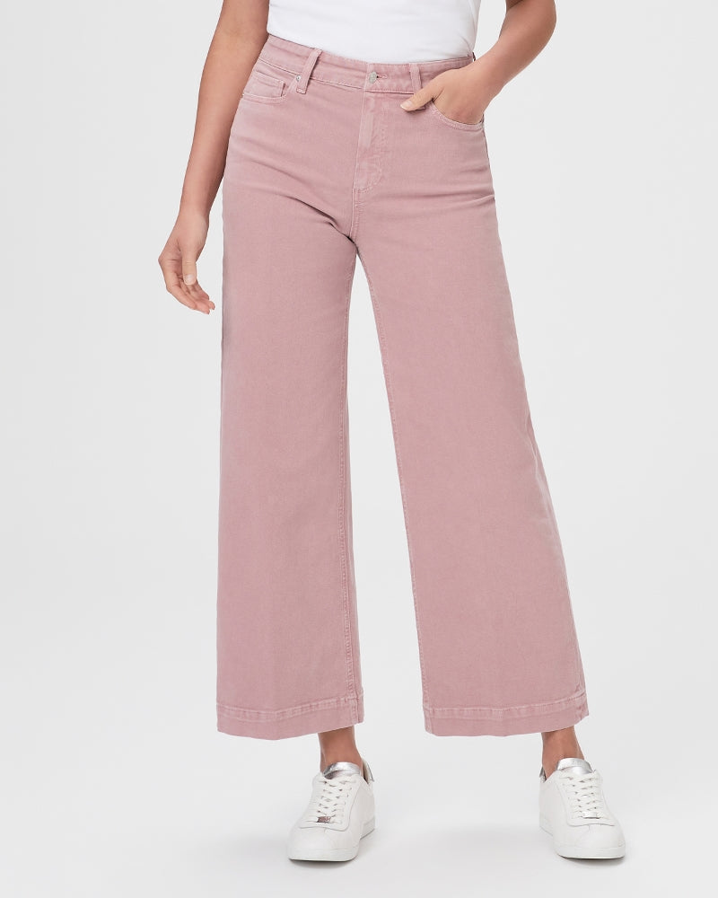 A woman wearing a pair of Paige Anessa Wide Leg - Vintage Muted Blush denim pants.