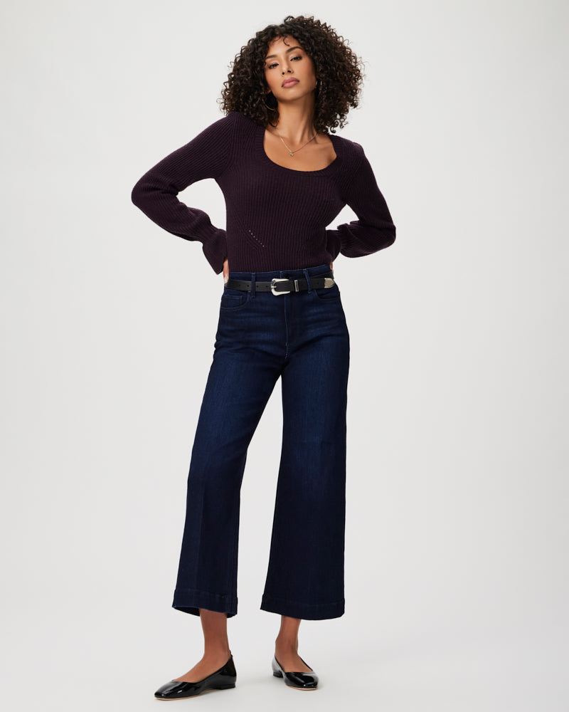 The model is wearing a purple top and vintage denim cropped jeans with Paige Anessa Wide Leg - Sussex.