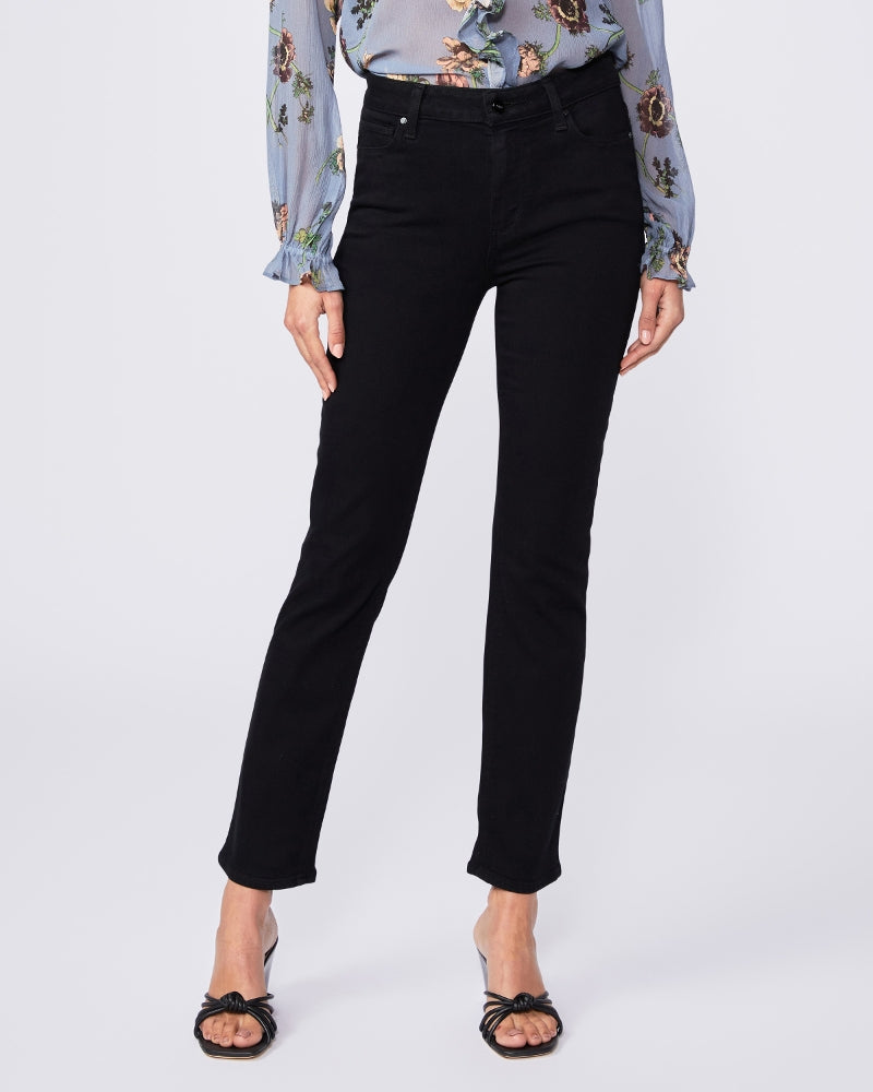 A woman wearing Paige Cindy Straight Ankle - Black Shadow jeans and a floral blouse.