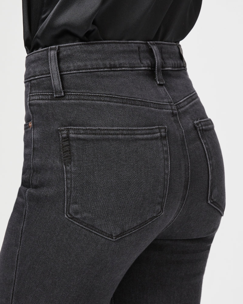 The back view of a woman wearing Paige Gemma Cigarette Jeans - Black Lotus.
