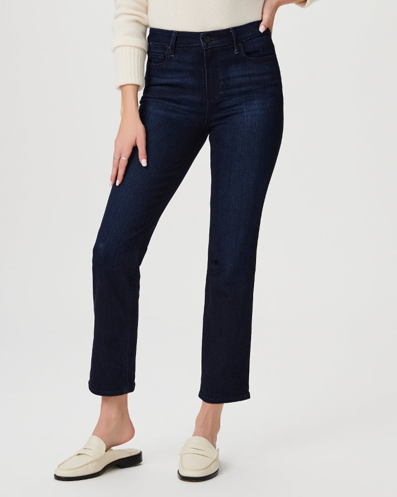 model wearing blue slim leg high waisted jeans