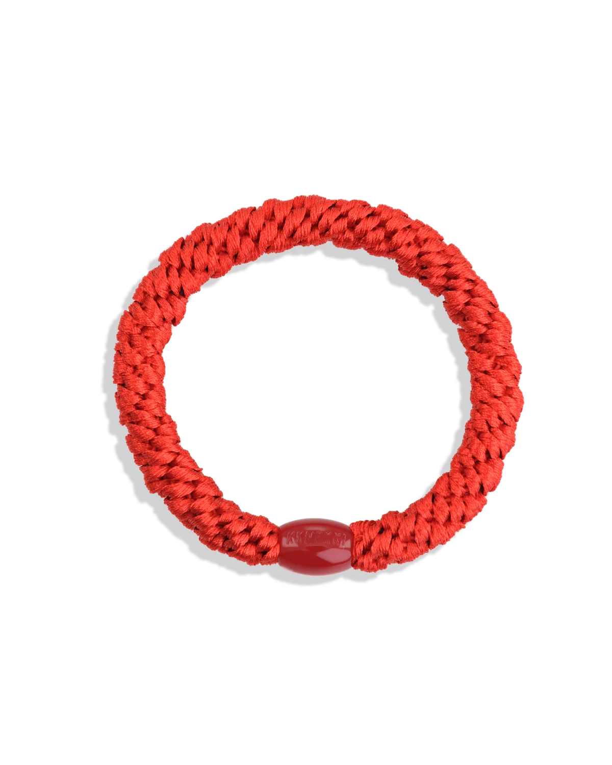 The KKNEKKI Hair Tie - Original is a red braided rope bracelet with a rounded bead clasp, known for its gentle grip and durability, shown on a plain white background.