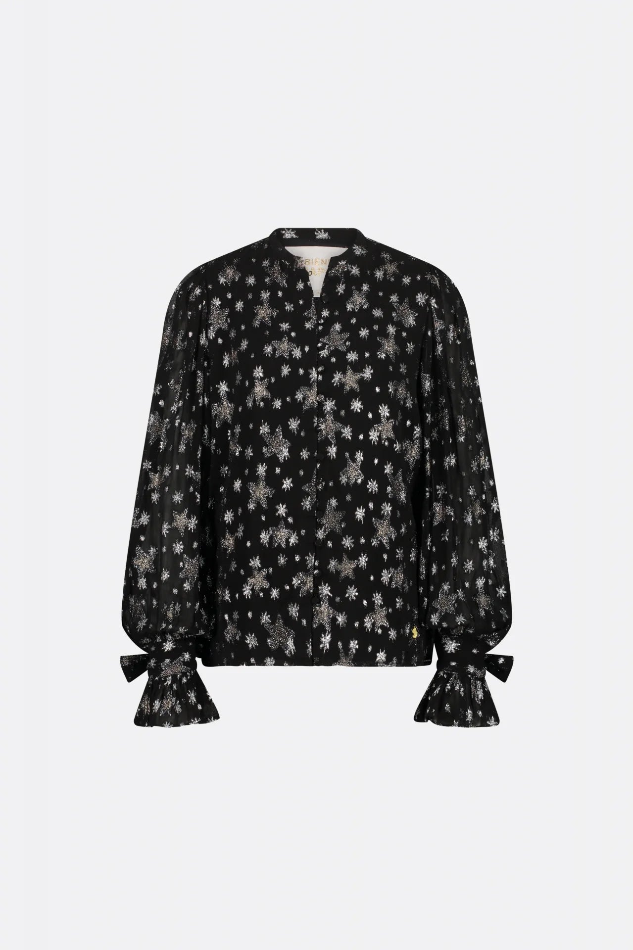 A black Kylie blouse with fabric-covered button closure and black flowers on it, by Fabienne Chapot.