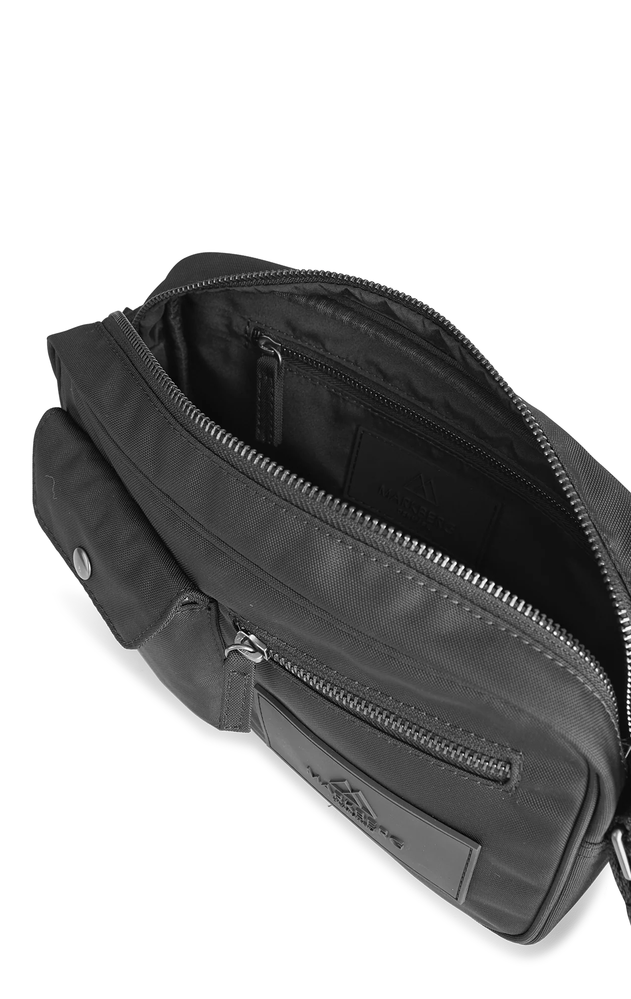 An open black waist bag, known as the Markberg Darla Bum Bag, with zippers on a transparent background, is crafted from vegan materials.