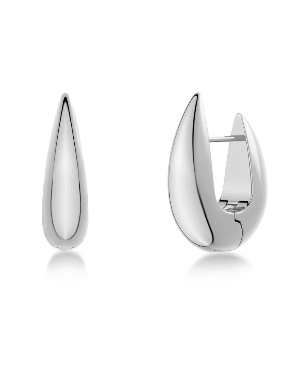 Behold the Crest Hoops L by EDBLAD: a pair of polished silver huggie earrings, with one displayed in front view and the other in side view. These sleek teardrop-shaped earrings are meticulously crafted from stainless steel.