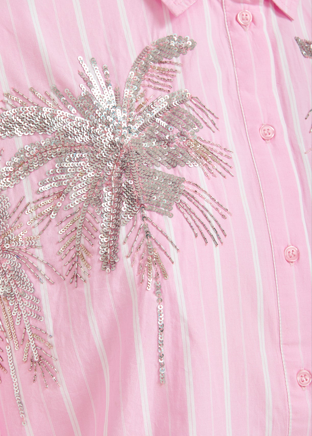 Close-up of a Essentiel Antwerp Fresh Shirt - Pink with silver sequin detail.