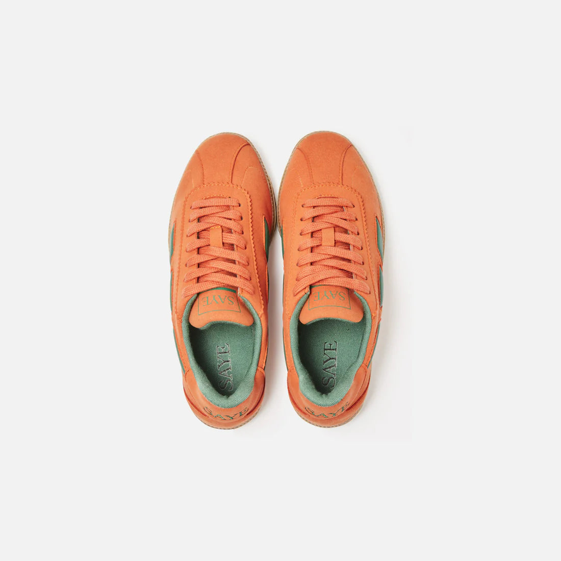 A pair of SAYE Modelo '70 Sneakers in orange vegan suede on a white surface.