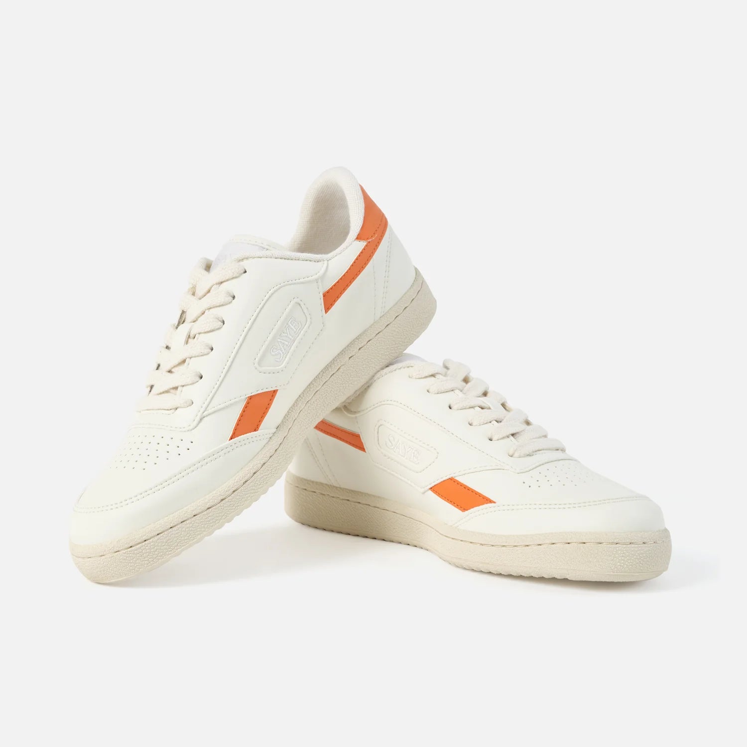 A pair of Modelo '89 Sneakers - Orange by SAYE on a white background.