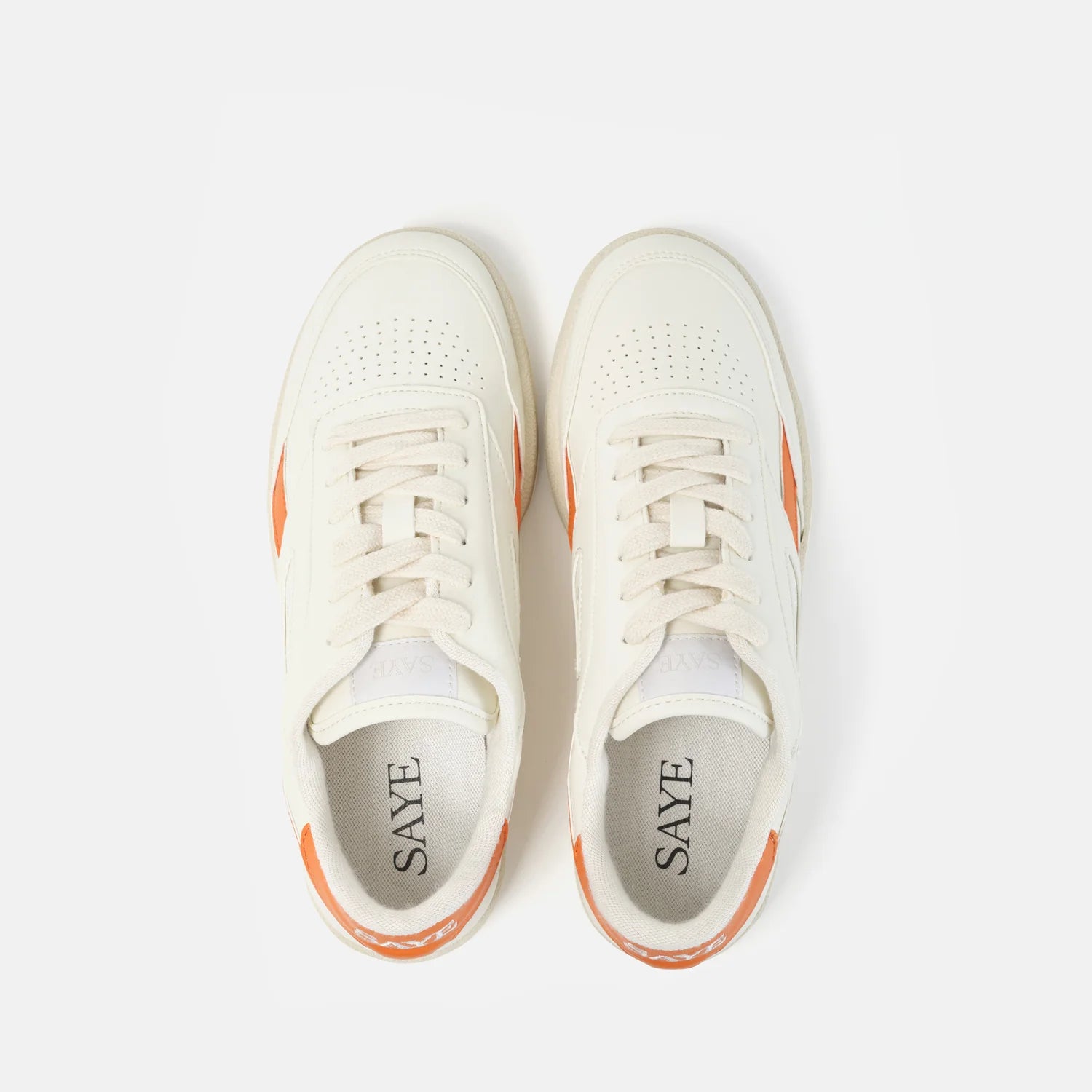 Pair of white SAYE 'Modelo '89 Sneakers - Orange' sneakers with orange accents, viewed from above.