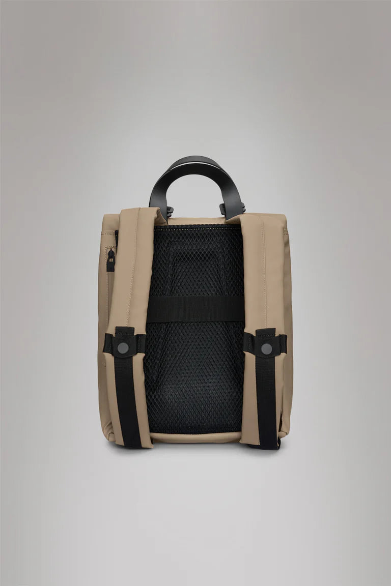 The Rains 2 Way Tote Backpack Mini in khaki features a padded mesh back, black adjustable shoulder straps, top handle, and side zip pocket—ideal for commuters seeking a compact, commuter-friendly design.