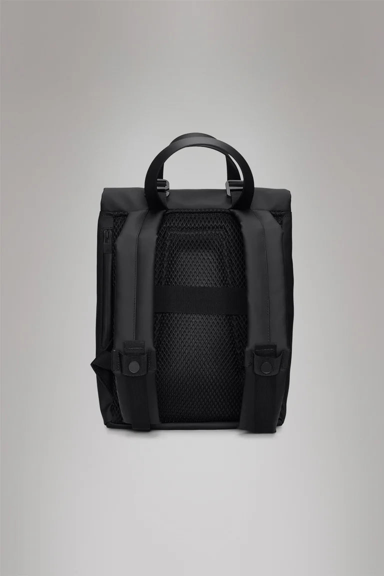 The Rains 2 Way Tote Backpack Mini is displayed from the back, highlighting its commuter-friendly design with a mesh panel, padded straps, carrying handle, and set against a matte grey background.