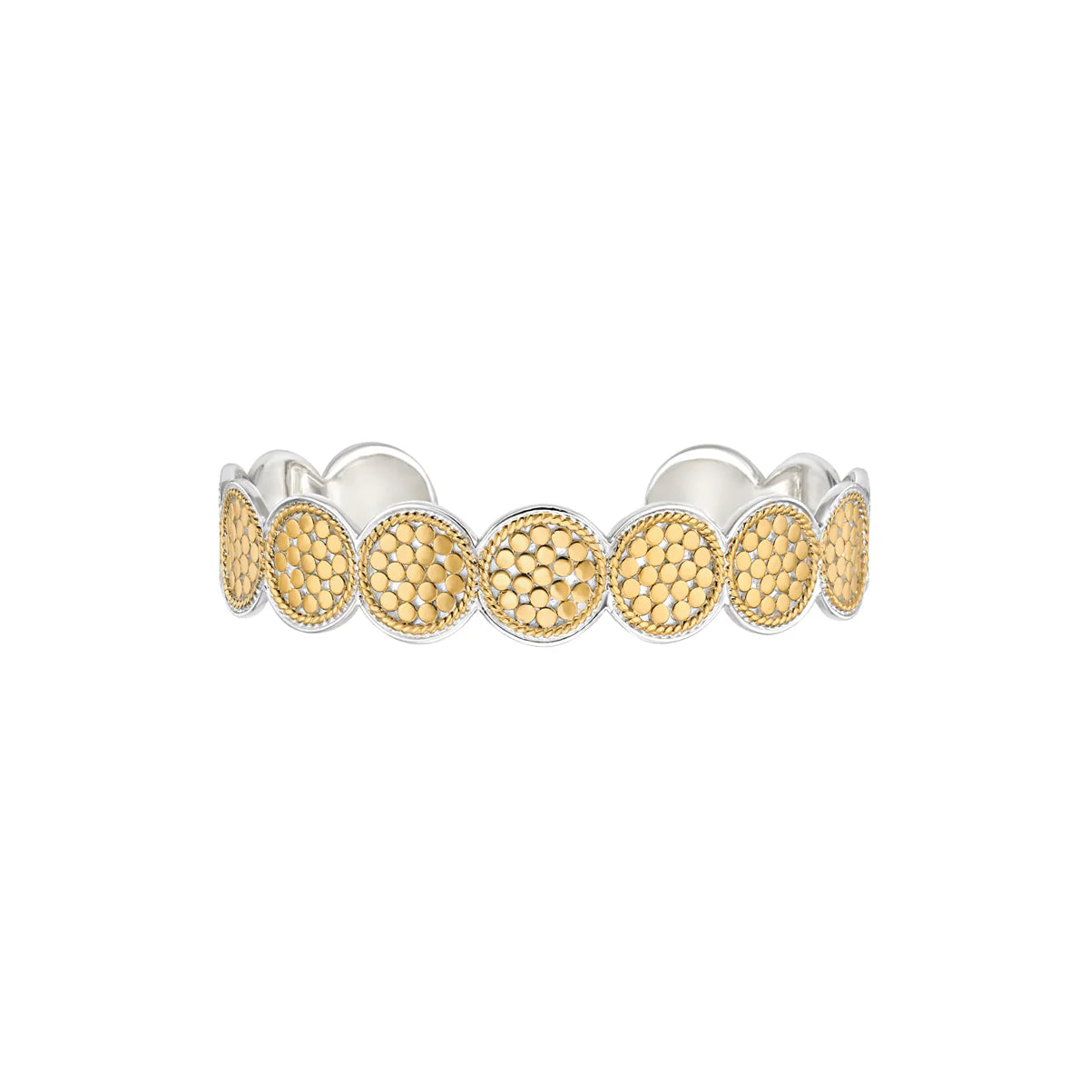 The Classic Multi-Disc Cuff - Gold by Anna Beck is a delicate cuff bracelet featuring a series of circular, textured patterns arranged in a continuous loop, adorned with 18k gold plating and handcrafted silver elements.