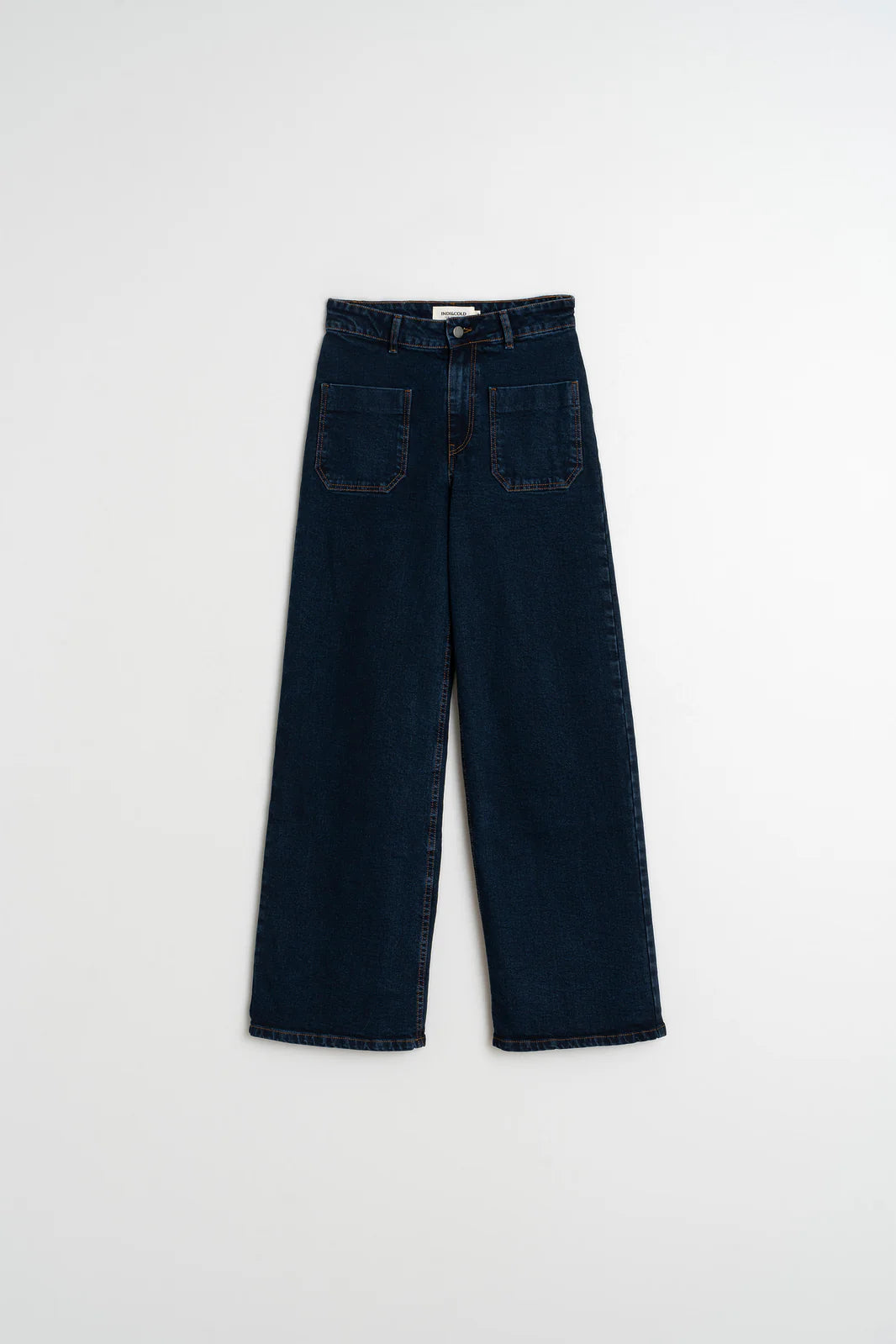 The Indi & Cold Wide Leg Denim Trousers in navy, featuring a high waist and front patch pockets, are shown laid flat on a white background.