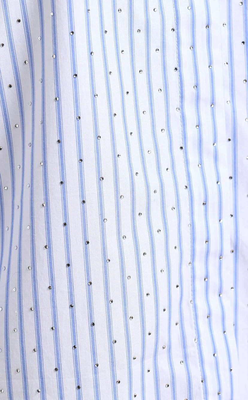 Close-up of the Kalmia Embellished Shirt by Essentiel Antwerp, showcasing off-white fabric with vertical blue pinstripes and small, evenly spaced rhinestone embellishments.