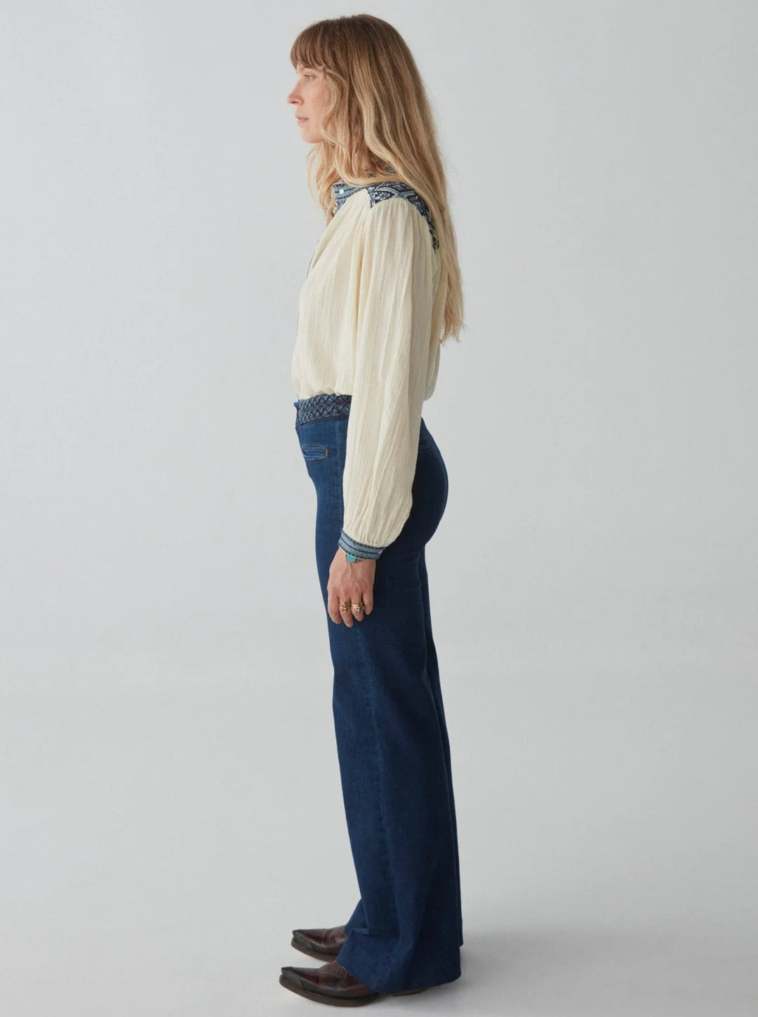 woman wears blue jeans by maison hotel