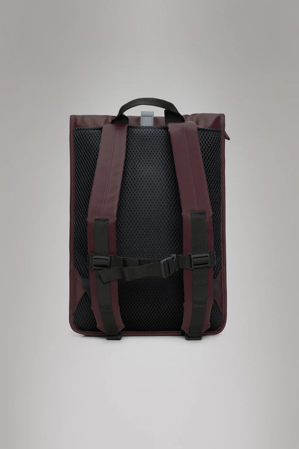 The Rains Rolltop Rucksack - Depth in maroon features a black mesh back panel, black adjustable straps, and a top handle, designed for bike commutes. Shown from the rear against a plain background.