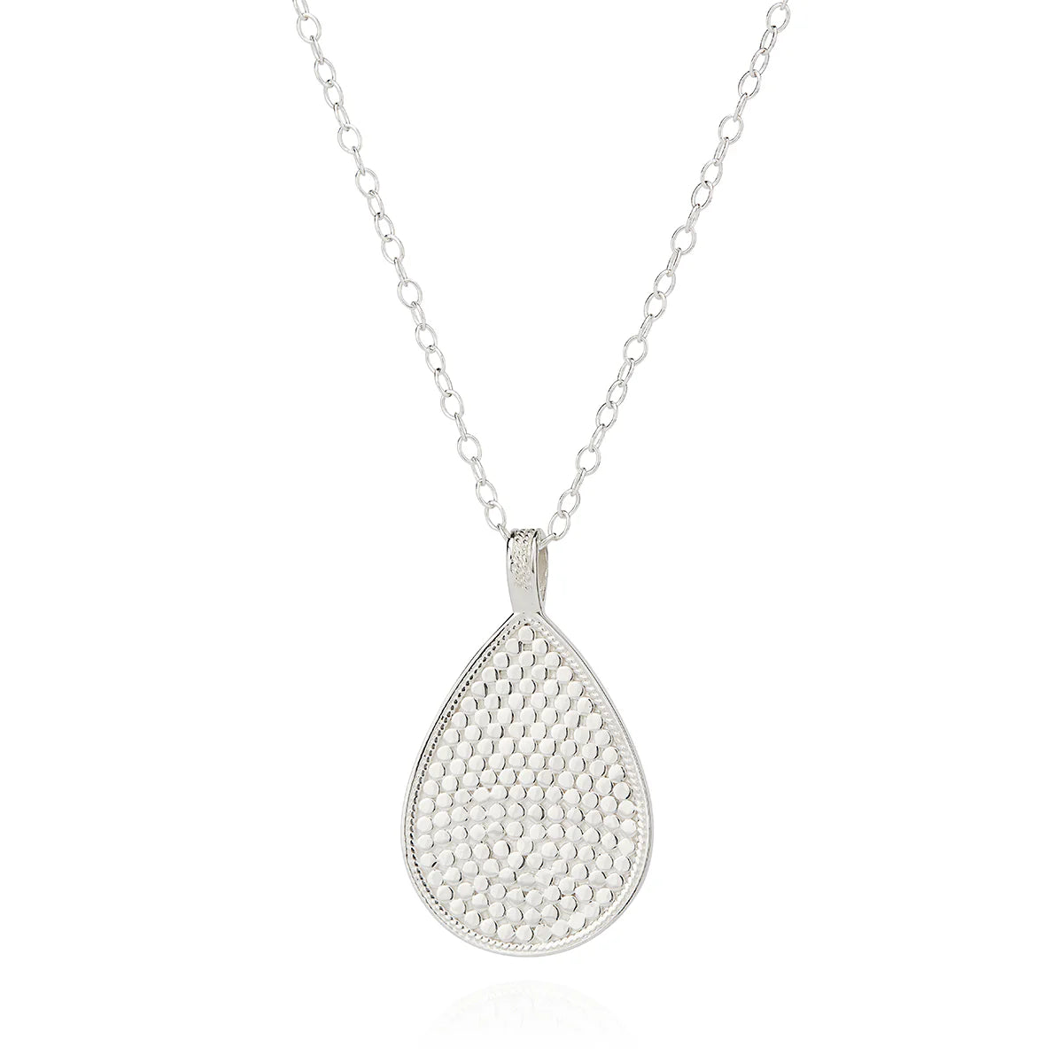 The Classic Large Teardrop Necklace - Reversible by Anna Beck, featuring a handcrafted silver teardrop-shaped pendant with a textured surface, hangs elegantly from a fine sterling silver chain.